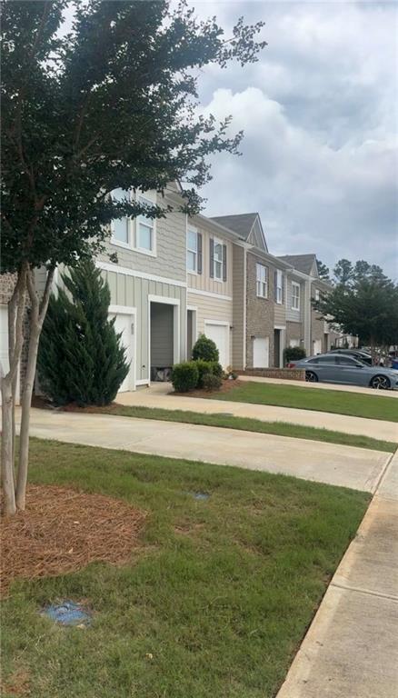 11900 Fuller Street Hampton, GA 30228 - Photo 2 of 17 a front view of a house with a yard