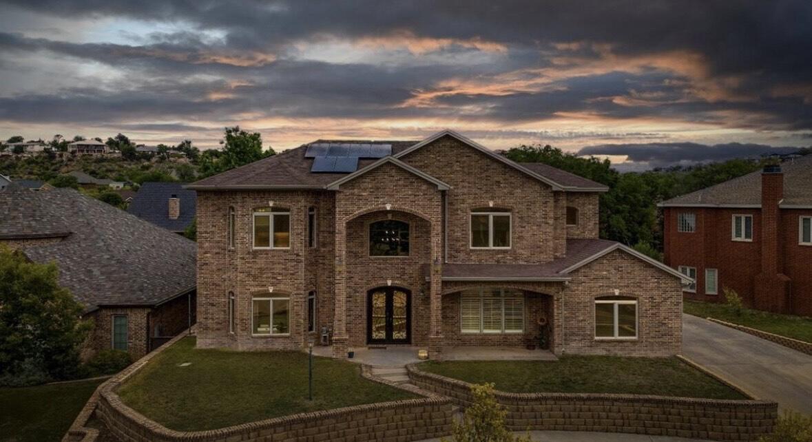 a front view of a house with a garden