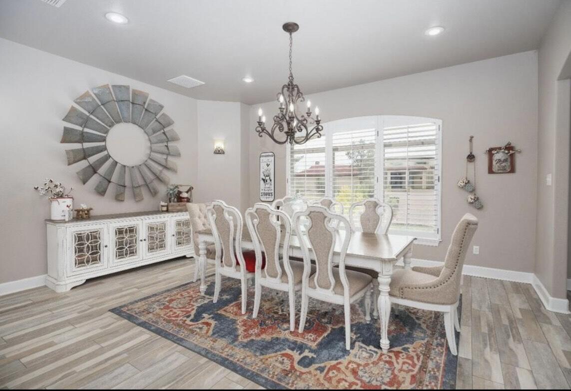 8 West Lakeshore Drive Ransom Canyon, TX 79366 - Photo 13 of 44 a view of a dining room with furniture and chandelier