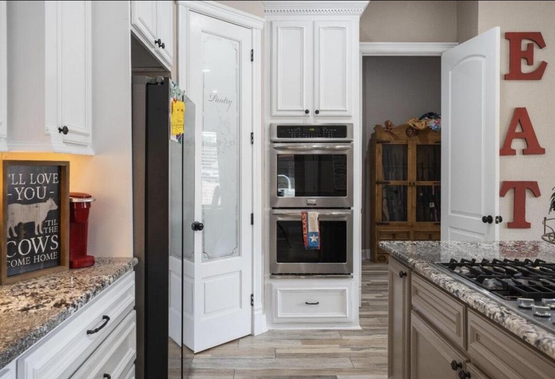 8 West Lakeshore Drive Ransom Canyon, TX 79366 - Photo 16 of 44 a kitchen with stainless steel appliances kitchen island granite countertop a stove and a refrigerator