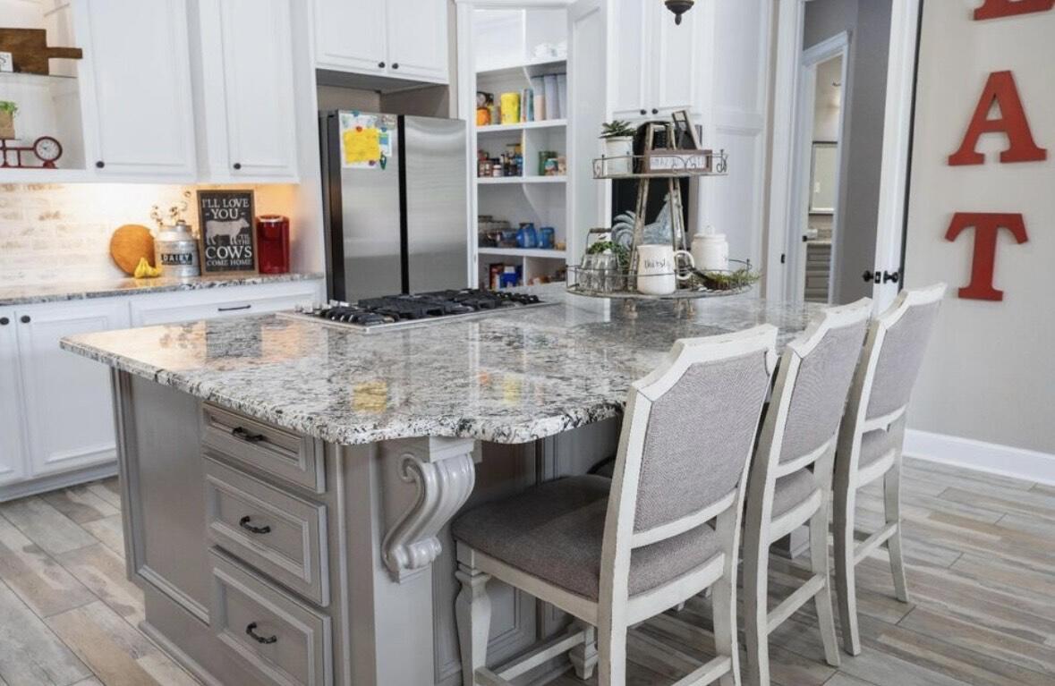 8 West Lakeshore Drive Ransom Canyon, TX 79366 - Photo 21 of 44 a view of dining table chairs and chandelier