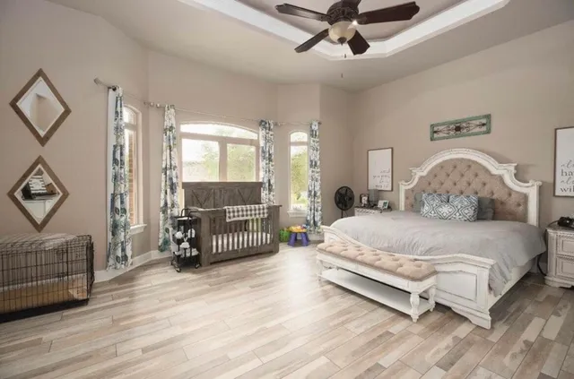 a bedroom with a bed and a chandelier