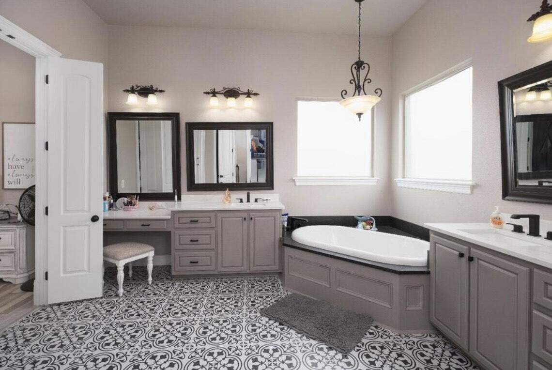 8 West Lakeshore Drive Ransom Canyon, TX 79366 - Photo 29 of 44 a bathroom with a toilet a sink a mirror a window and vanity