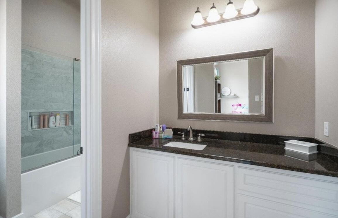 8 West Lakeshore Drive Ransom Canyon, TX 79366 - Photo 34 of 44 a bathroom with a sink and a mirror