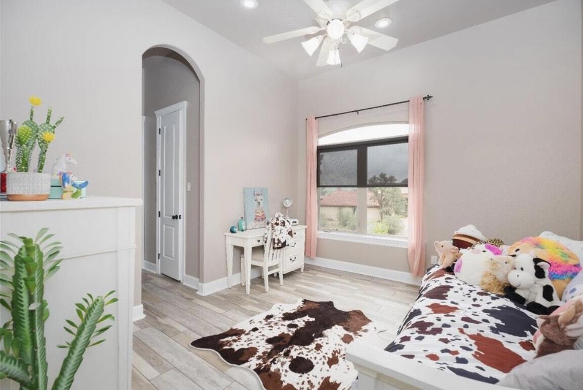 8 West Lakeshore Drive Ransom Canyon, TX 79366 - Photo 35 of 44 a bedroom with furniture and a potted plant