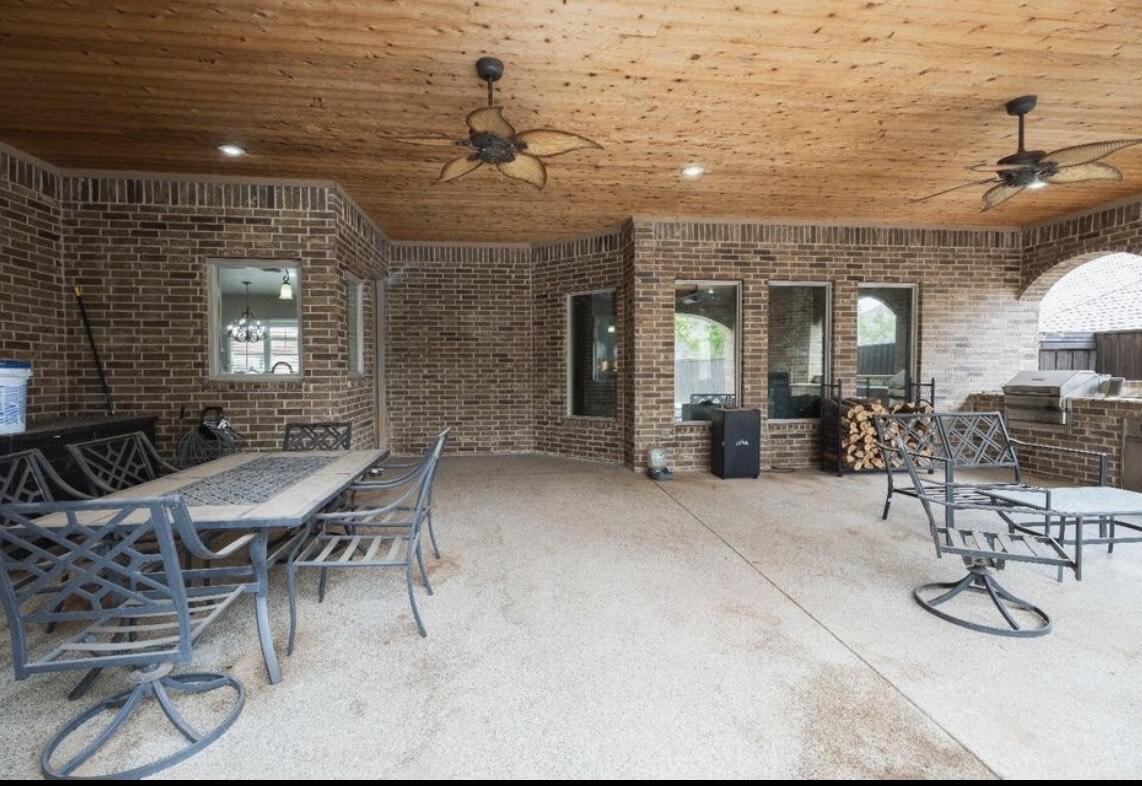 8 West Lakeshore Drive Ransom Canyon, TX 79366 - Photo 41 of 44 a view of a patio with table and chairs and potted plants
