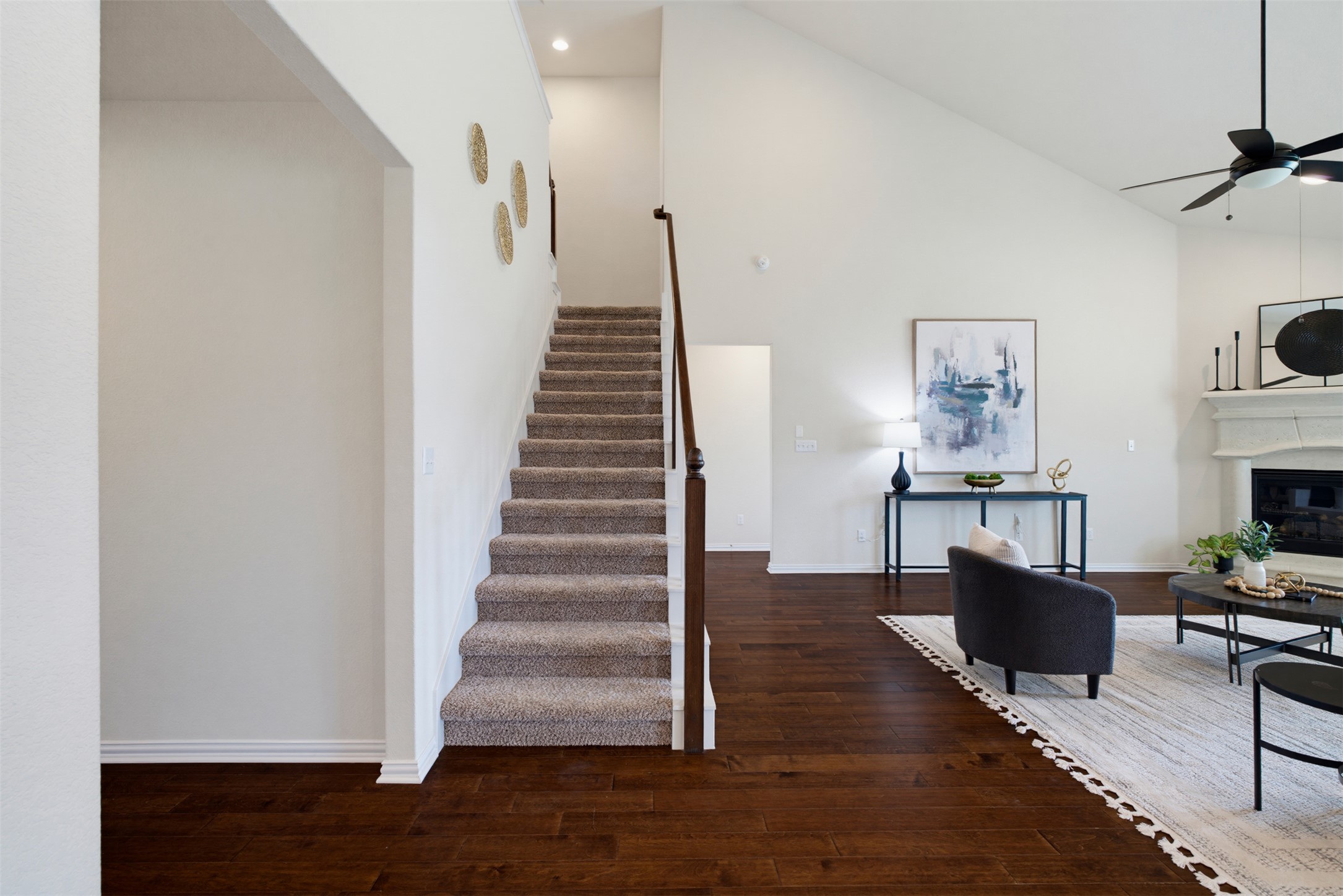 12613 Twisted Root Drive Manchaca, TX 78652 - Photo 26 of 33 Hardwood floors complement the soaring vaulted ceiling, creating a grand and inviting space.