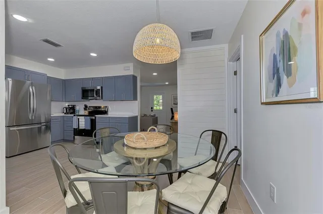 a kitchen with a dining table and chairs