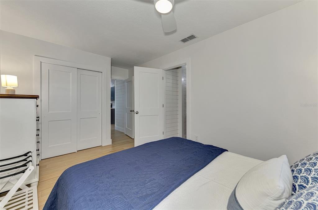 1100 Point Of Rocks Road Sarasota, FL 34242 - Photo 22 of 53 a bedroom with a bed and a chandelier