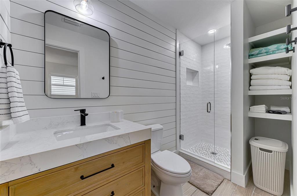 1100 Point Of Rocks Road Sarasota, FL 34242 - Photo 23 of 53 a bathroom with a sink a toilet and shower