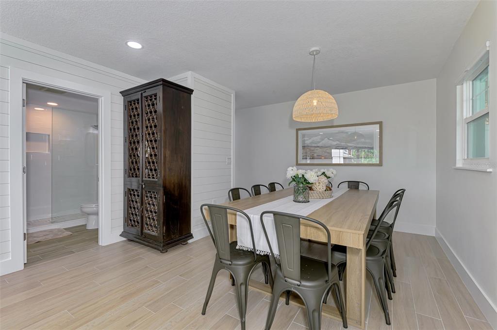 1100 Point Of Rocks Road Sarasota, FL 34242 - Photo 29 of 53 a view of a dining room with furniture and wooden floor