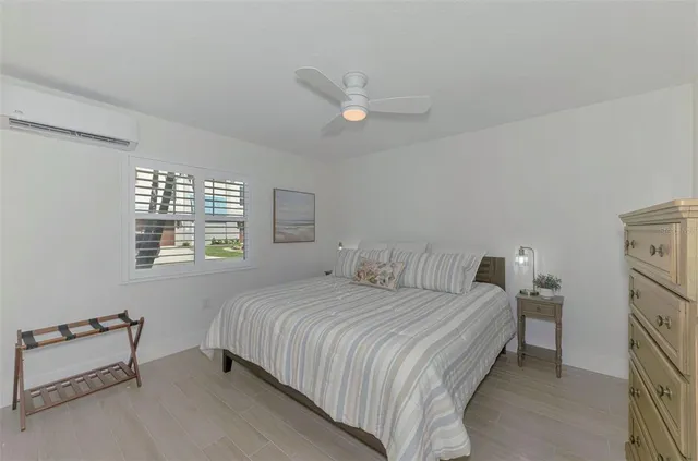 a bedroom with a bed and ceiling fan