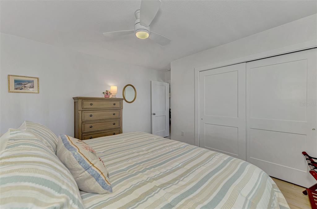 1100 Point Of Rocks Road Sarasota, FL 34242 - Photo 33 of 53 a bedroom with a bed and ceiling fan