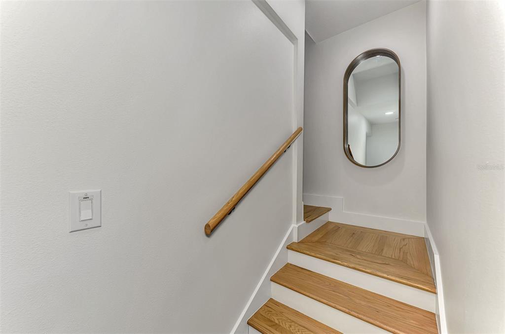 1100 Point Of Rocks Road Sarasota, FL 34242 - Photo 35 of 53 a room with wooden floor and a potted plant