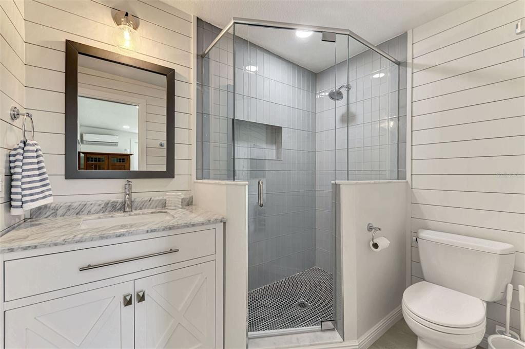 1100 Point Of Rocks Road Sarasota, FL 34242 - Photo 40 of 53 a bathroom with a granite countertop sink toilet and shower