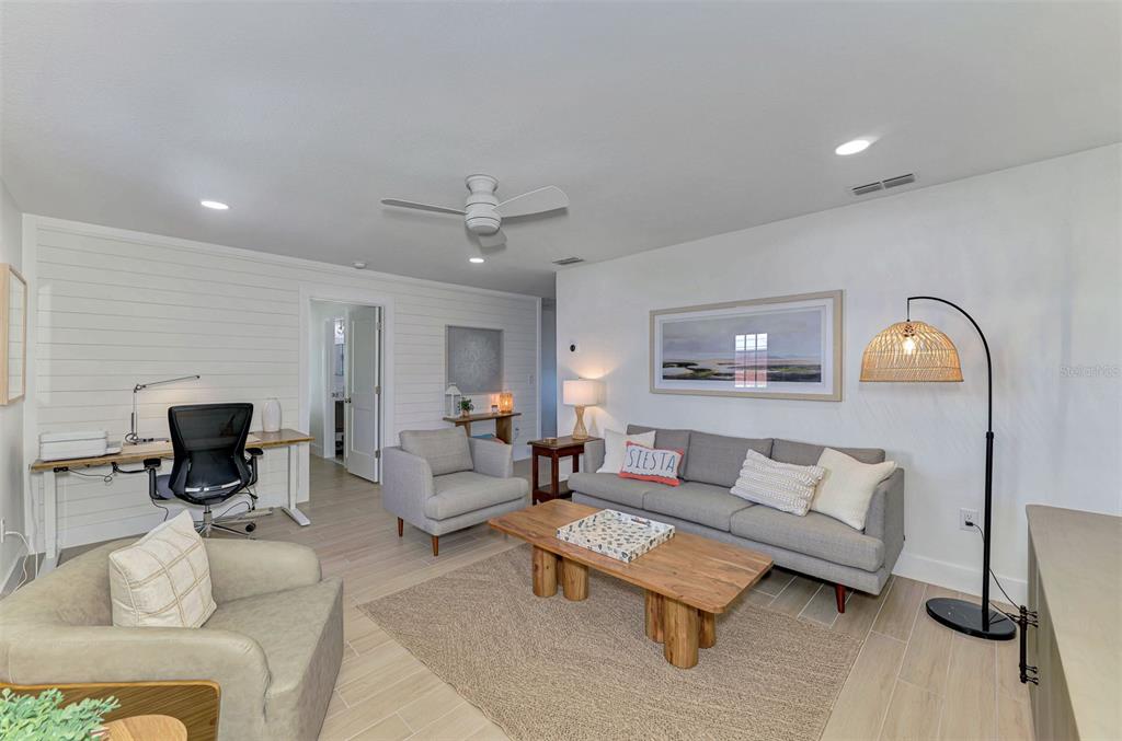 1100 Point Of Rocks Road Sarasota, FL 34242 - Photo 7 of 53 a living room with furniture and a flat screen tv
