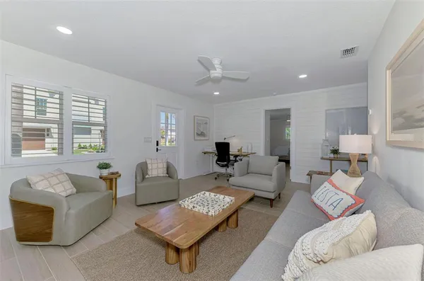 a living room with furniture and a large window