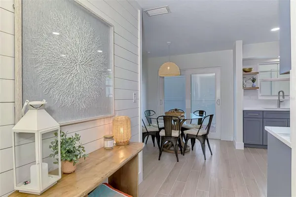 a view of a dining room with furniture and wooden floor