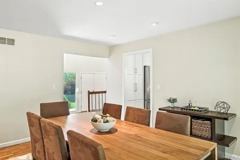 a dining room with furniture and wooden floor