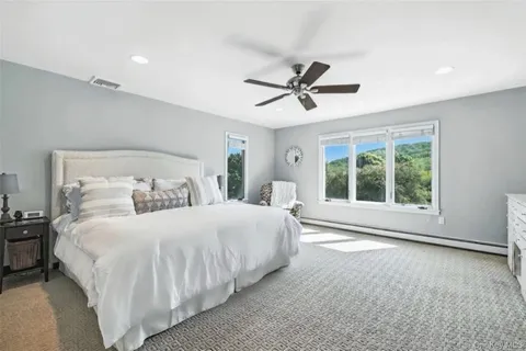 a bedroom with a large bed and a window