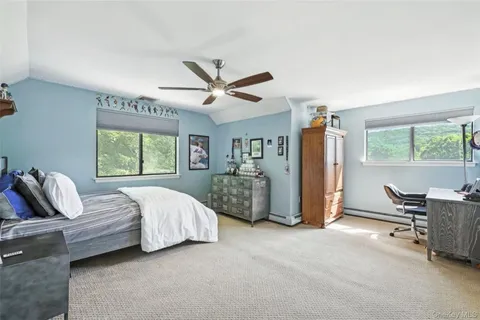 a bed room with a bed and a chair