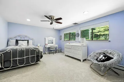 a bedroom with a bed and a chair