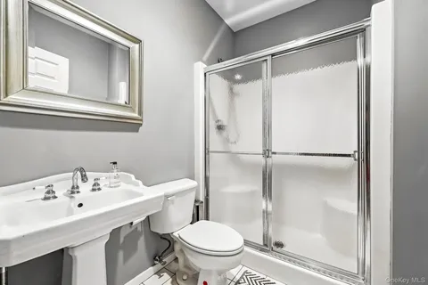 a bathroom with a sink toilet and shower