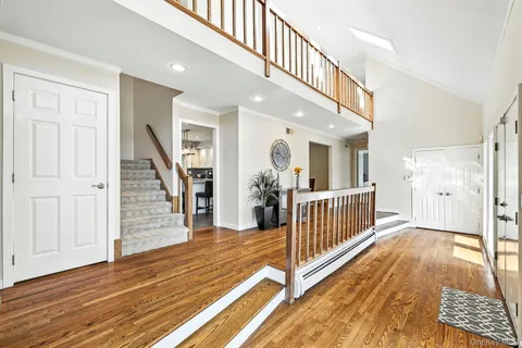 a view of entryway with wooden floor and stairs