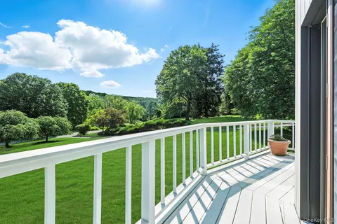 a balcony with wooden floor and fence