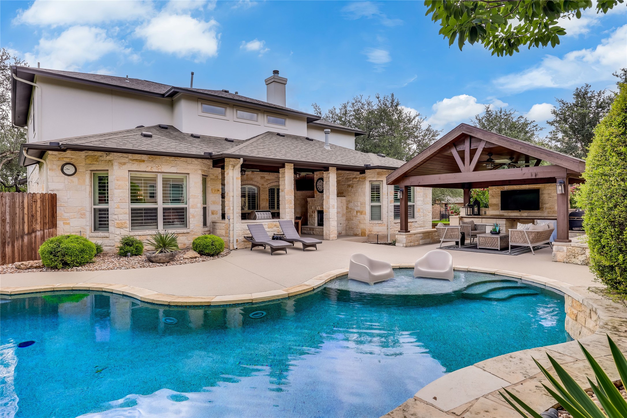 401 Bluff View Road Cedar Park, TX 78613 - Photo 8 of 40 An inviting backyard oasis awaits with a sparkling pool and a covered outdoor living area.