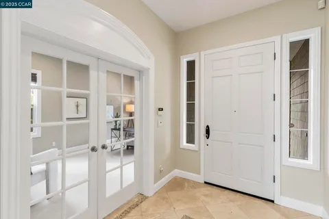 a living room with furniture a fireplace and a large window