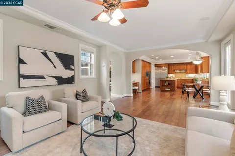 a kitchen with stainless steel appliances granite countertop a refrigerator a stove and a wooden floors