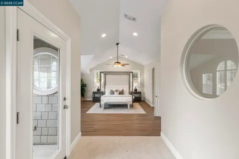 a bathroom with a granite countertop sink a toilet and a mirror