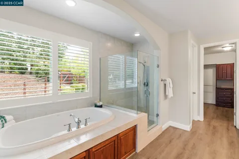 a bathroom with a granite countertop sink toilet a large mirror and shower