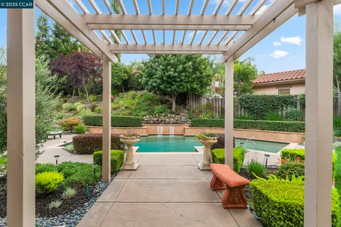 a backyard of a house with yard barbeque oven and outdoor seating