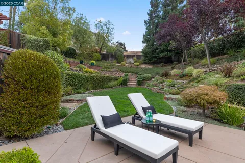 a view of a house with a yard and sitting area