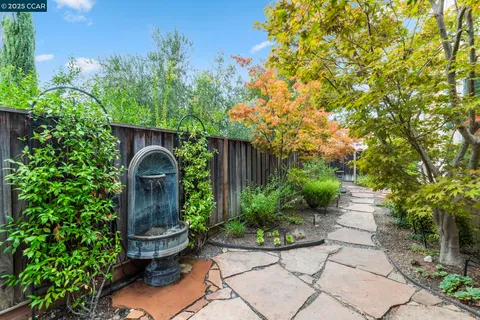 a front view of a house with a yard and potted plants