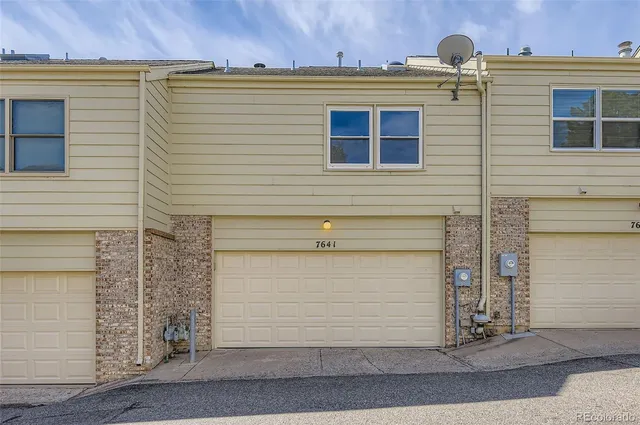 a front view of a house with garage
