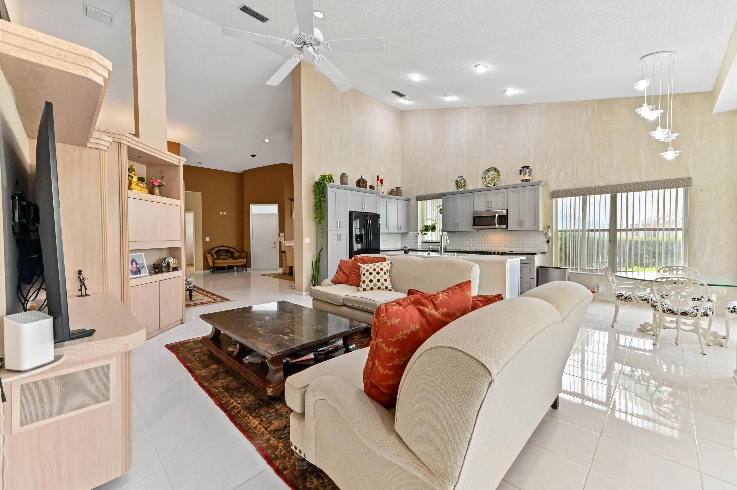 8319 Horseshoe Bay Road Boynton Beach, FL 33472 - Photo 13 of 69 a living room with stainless steel appliances furniture a rug and a kitchen view