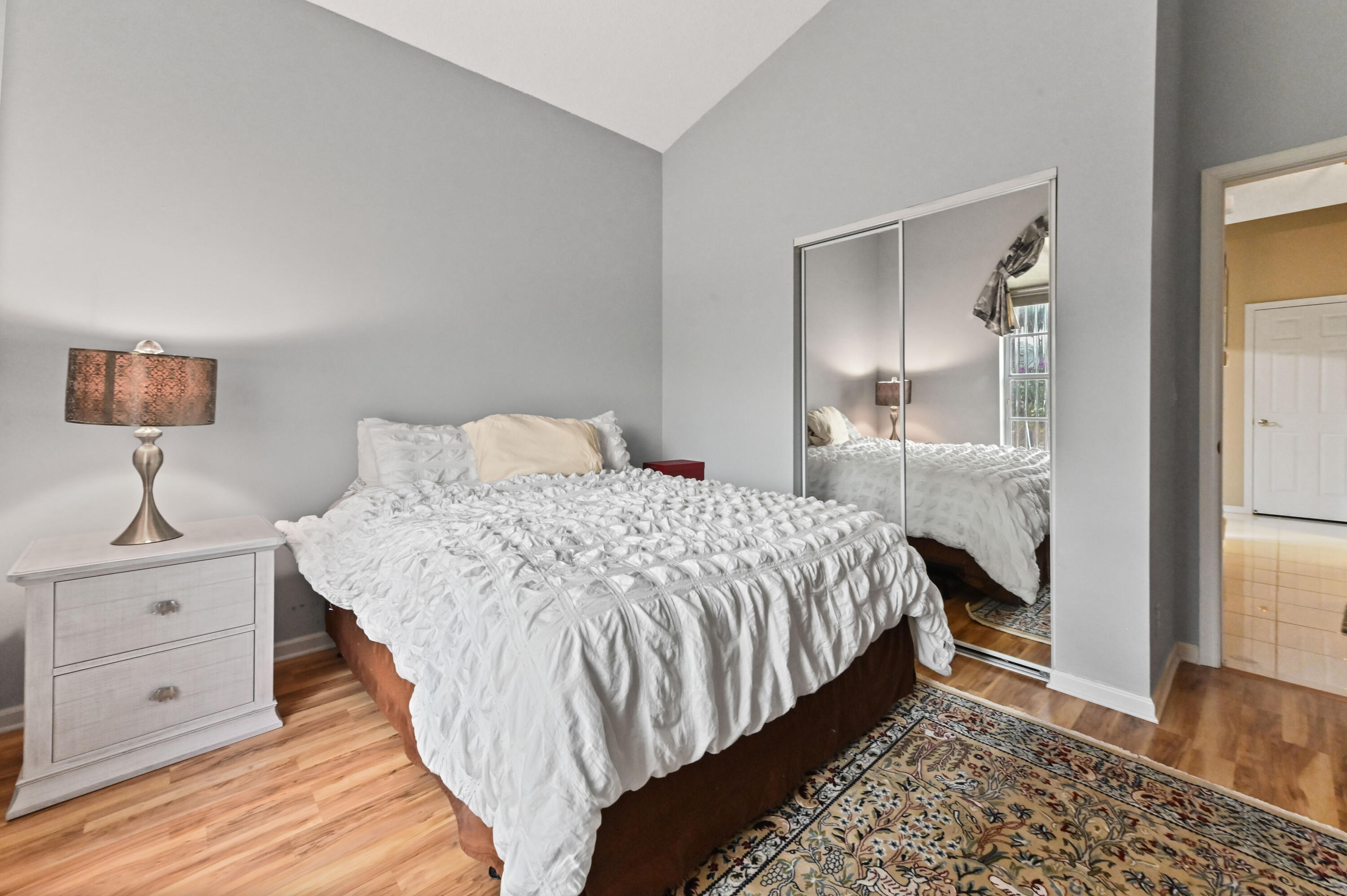 8319 Horseshoe Bay Road Boynton Beach, FL 33472 - Photo 24 of 69 a bedroom with a bed and a lamp on table