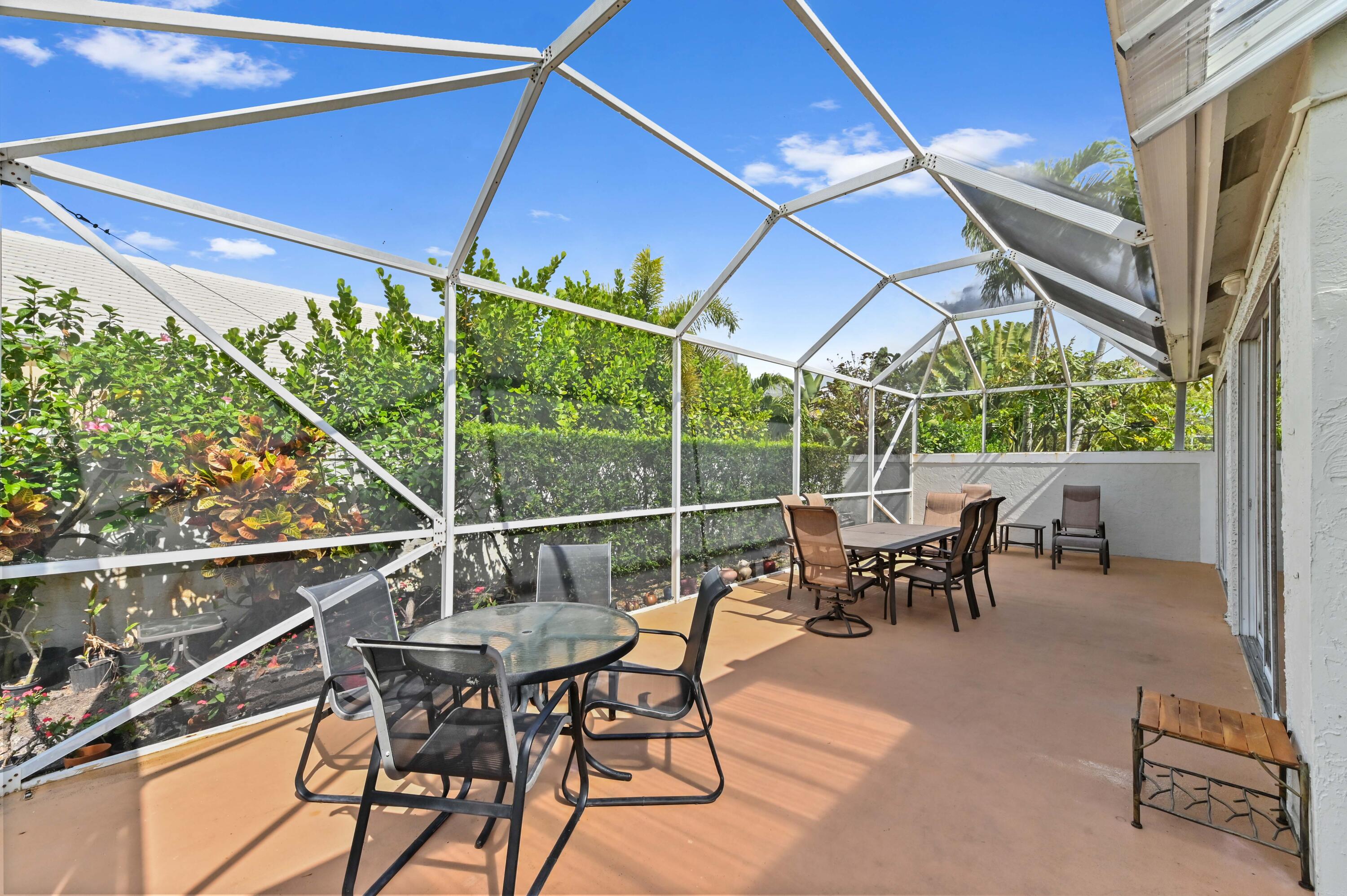 8319 Horseshoe Bay Road Boynton Beach, FL 33472 - Photo 32 of 69 a patio with table and chairs