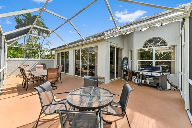 a outdoor space with lots of wooden furniture and a chandelier