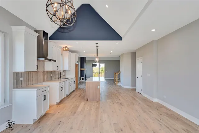 a large kitchen with a table and chairs