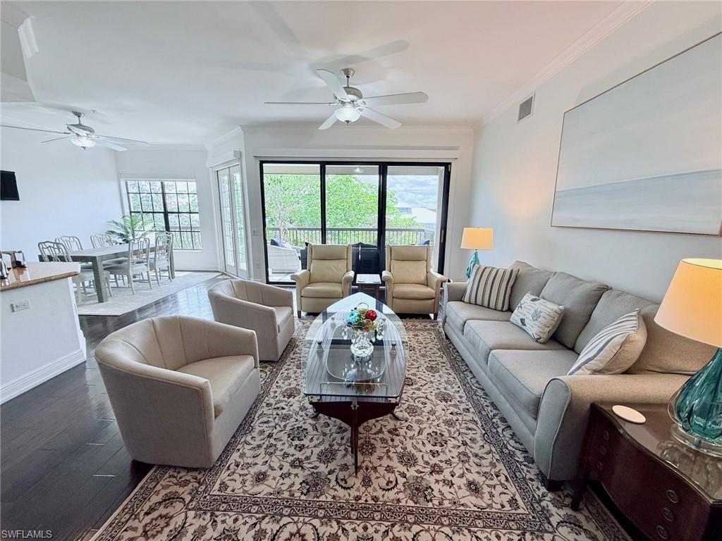 705 10th Street South, Unit 301 Naples, FL 34102 - Photo 2 of 35 a living room with furniture and a large window