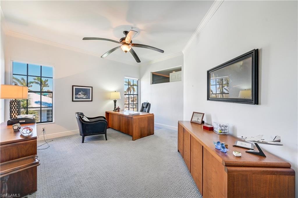 705 10th Street South, Unit 301 Naples, FL 34102 - Photo 21 of 35 a living room with furniture and a flat screen tv