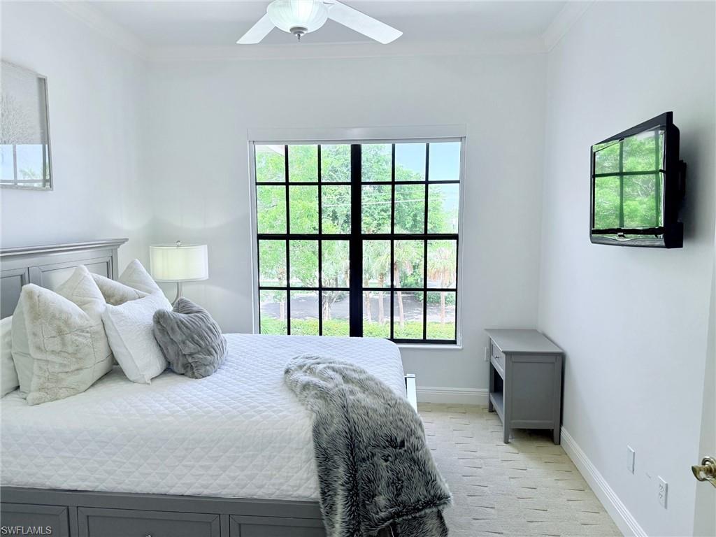 705 10th Street South, Unit 301 Naples, FL 34102 - Photo 25 of 35 a bedroom with a bed and a window