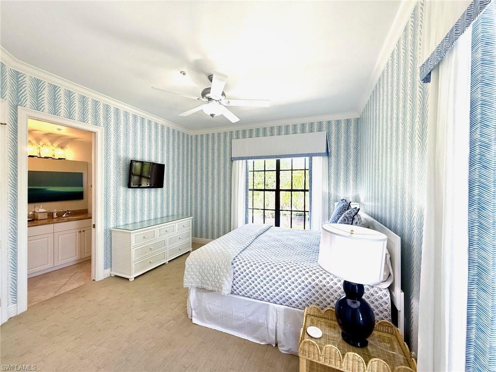 705 10th Street South, Unit 301 Naples, FL 34102 - Photo 29 of 35 a bedroom with a bed and a television