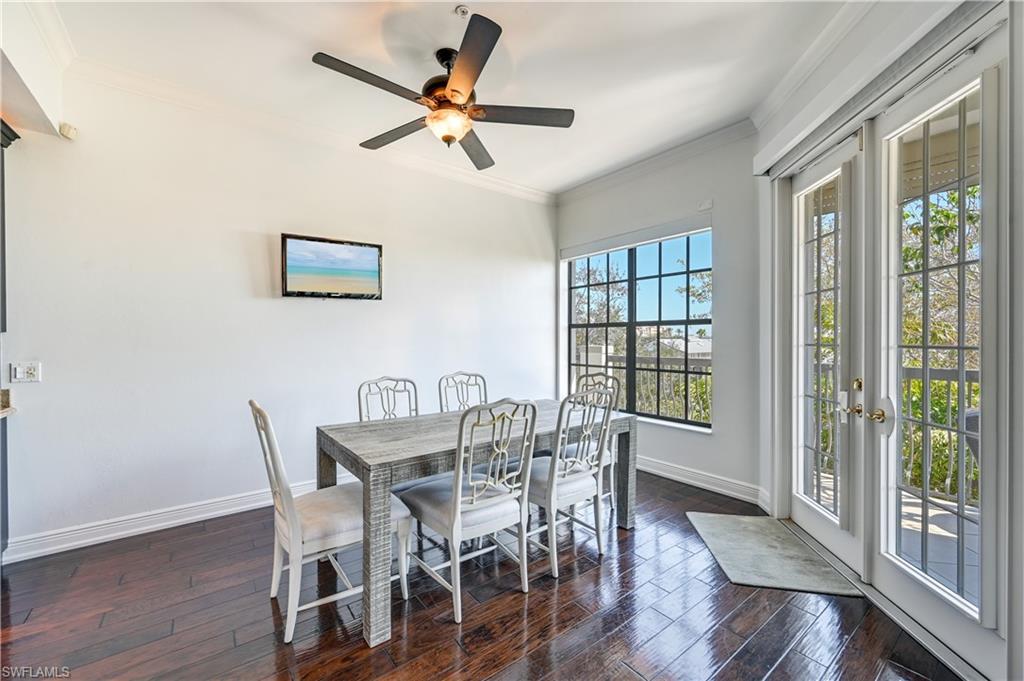 705 10th Street South, Unit 301 Naples, FL 34102 - Photo 8 of 35 a view of a dining room with furniture window and wooden floor