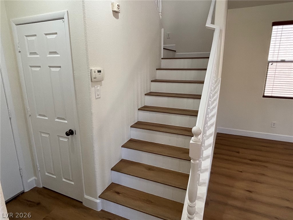 4900 Naff Ridge Drive Las Vegas, NV 89131 - Photo 9 of 21 Clean lines and a striking staircase lead to the upper level of this inviting residence.