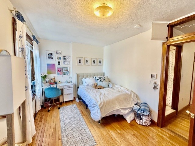 11 Foster Street, Unit 5 Boston, MA 02109 - Photo 12 of 19 a bedroom with a bed and wooden floor